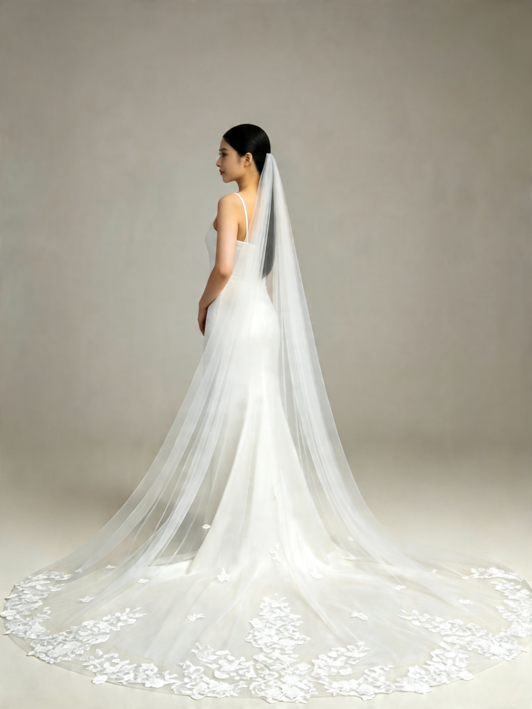 Side view of bride wearing sweet scattered floral cathedral wedding veil, sheer tulle and lace hem