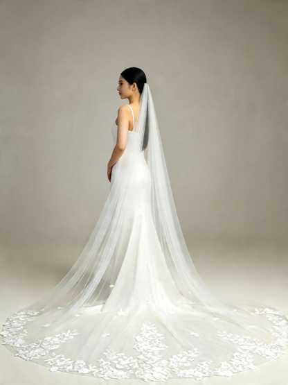 Side view of bride wearing sweet scattered floral cathedral wedding veil, sheer tulle and lace hem