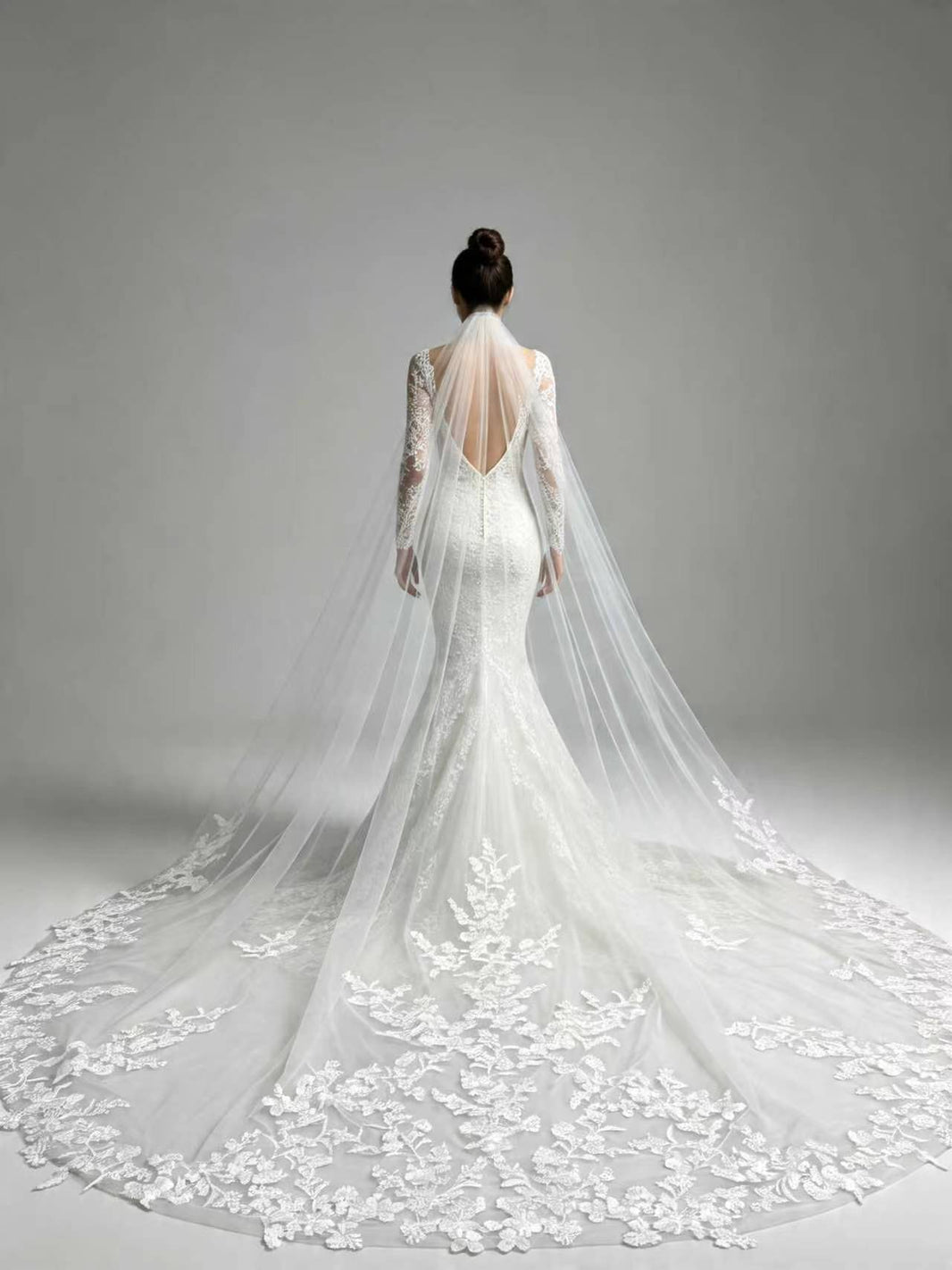 Back view of bride wearing statement full floral lace cathedral wedding veil, couture bridal silhouette