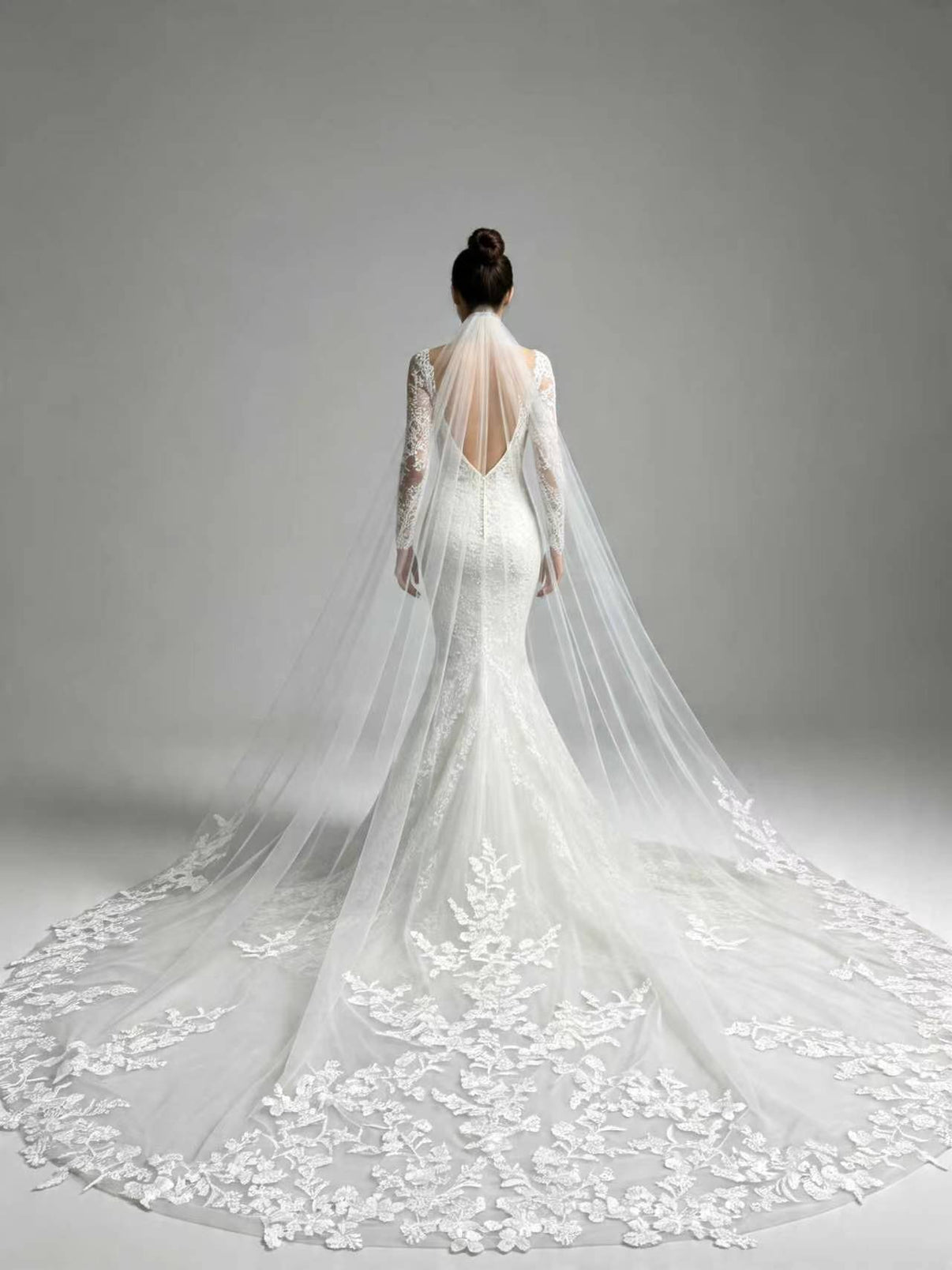 Back view of bride wearing statement full floral lace cathedral wedding veil, couture bridal silhouette