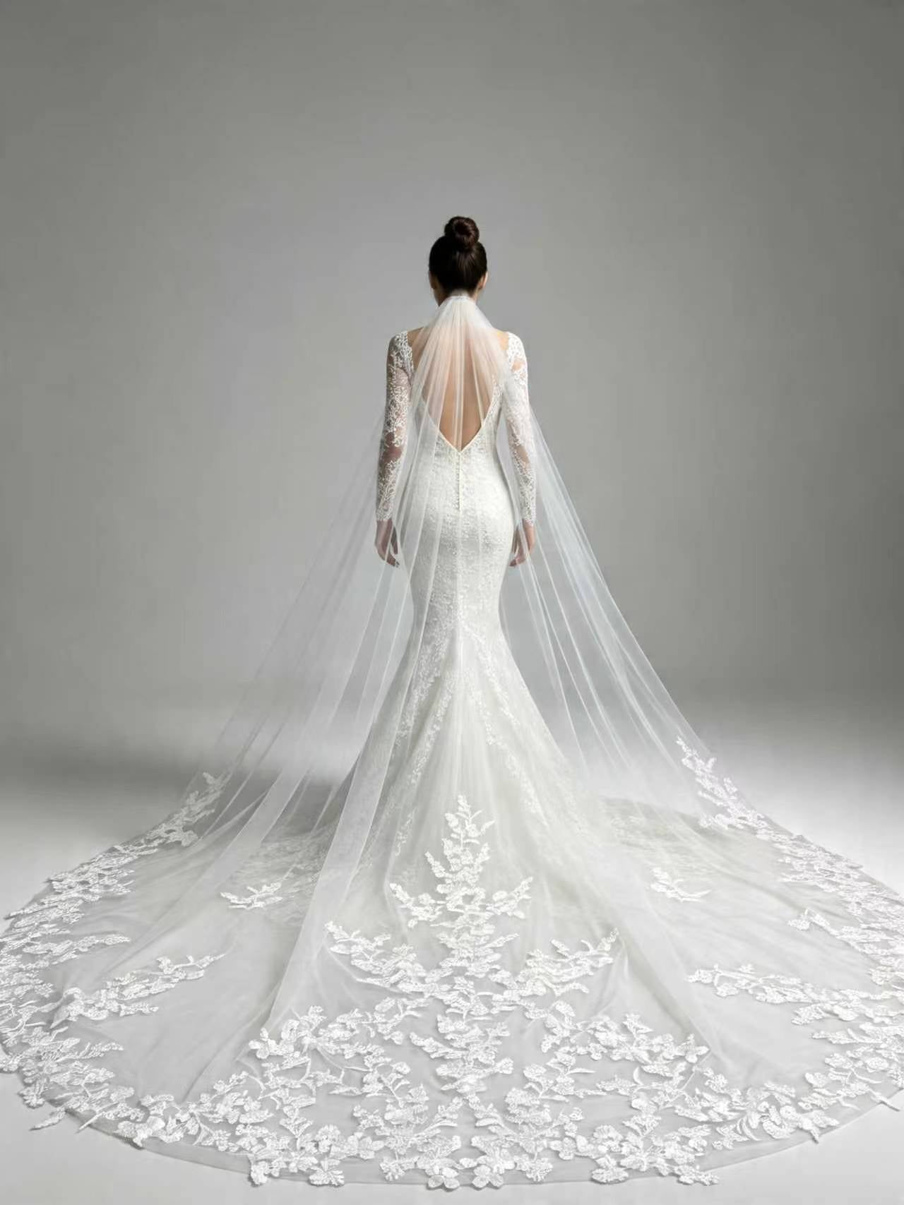 Back view of bride wearing statement full floral lace cathedral wedding veil, couture bridal silhouette