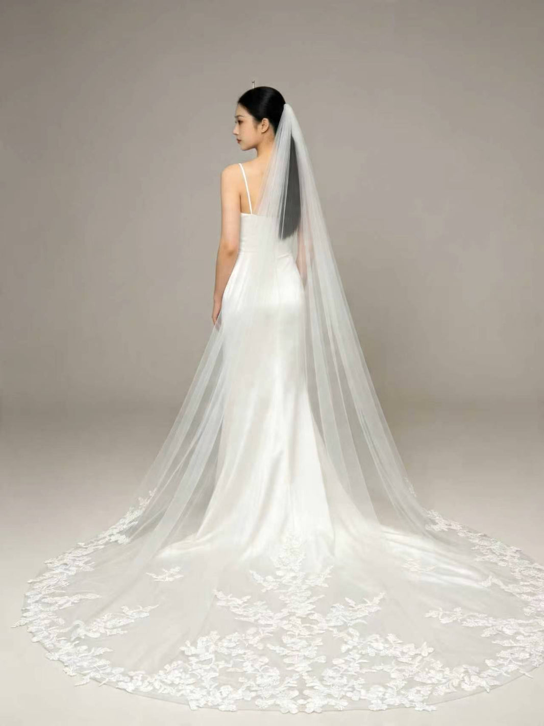 Back view of bride wearing statement full floral lace cathedral wedding veil, couture bridal silhouette