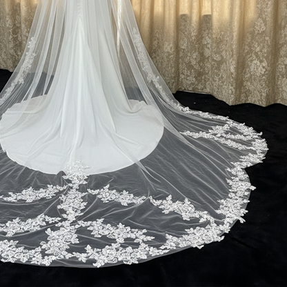 Close-up of irregular scattered lace on non-traditional cathedral veil