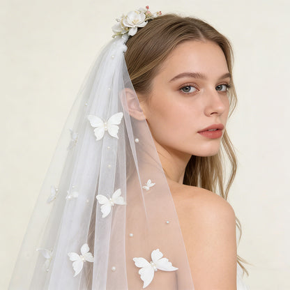 Bride wearing romantic butterfly pearl cathedral veil, close-up view of 3D butterfly and pearl details