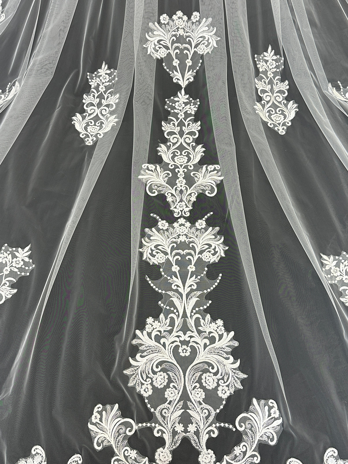 Close-up of ascending floral lace embroidery on Celestial Bloom cathedral tulle veil, intricate bridal detail