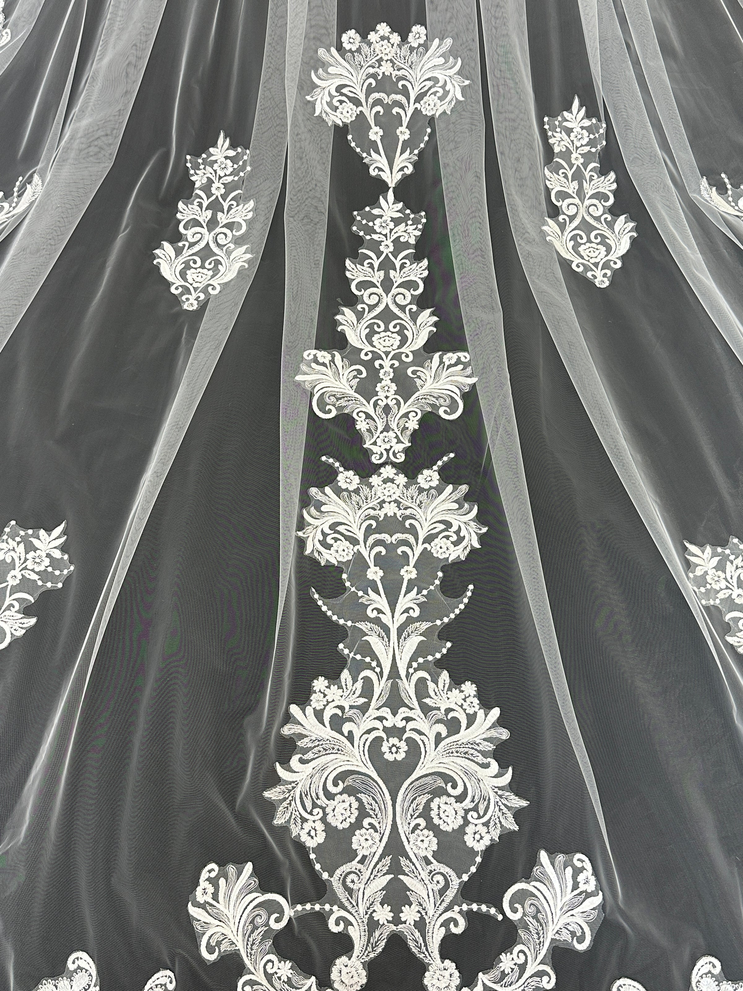 Close-up of ascending floral lace embroidery on Celestial Bloom cathedral tulle veil, intricate bridal detail