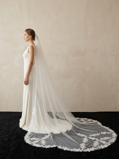 Bride wearing non-traditional irregular lace cathedral wedding veil