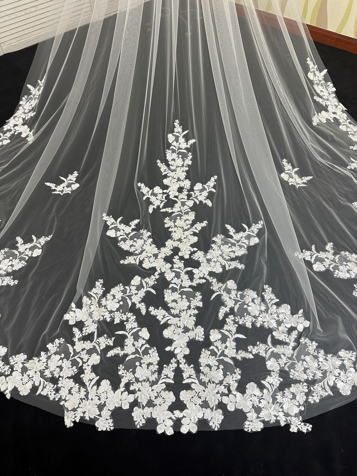 Close-up of intricate full floral lace on luxury cathedral wedding veil, delicate bridal detail