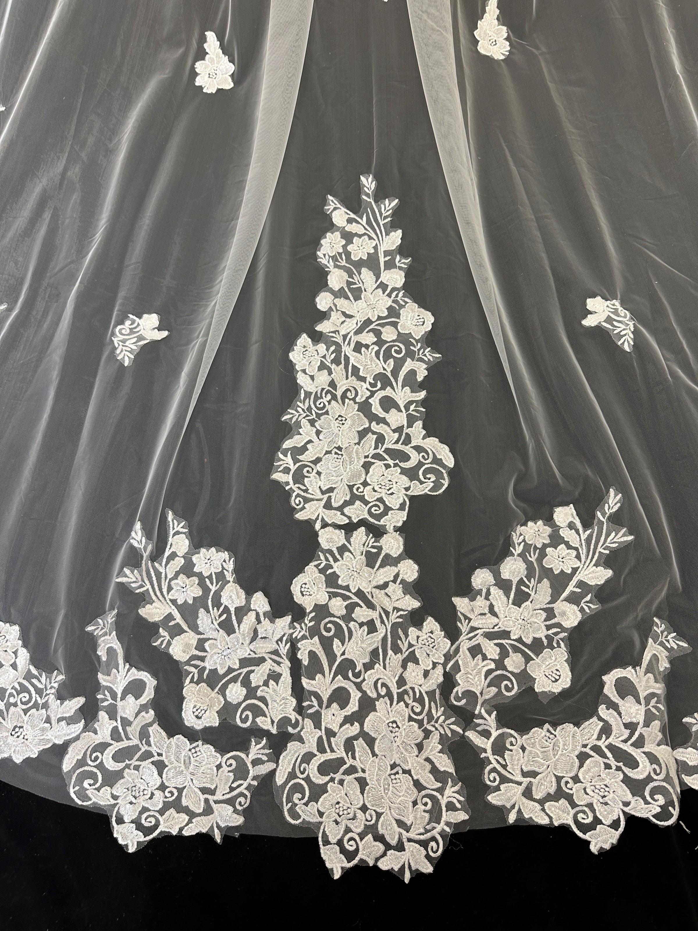 Close-up of delicate scattered floral embroidery on cathedral wedding veil 