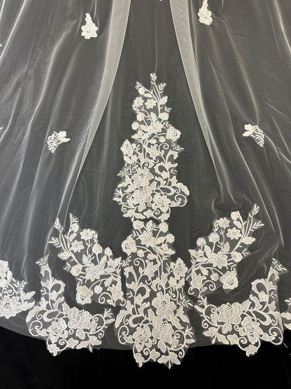Close-up of delicate scattered floral embroidery on cathedral wedding veil 